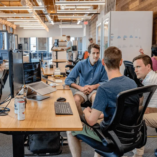 Marketing team collaborating around a desk